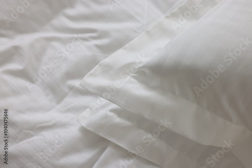 Bed with clean linens and pillows at home, closeup