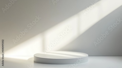 Minimalist studio setting with natural light highlighting a circular platform on a clean background