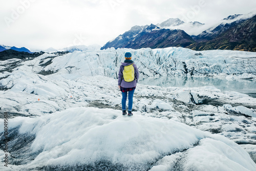 Woman is hiking on Matanuska Glacier near Glenn Highway in Alaska. photo