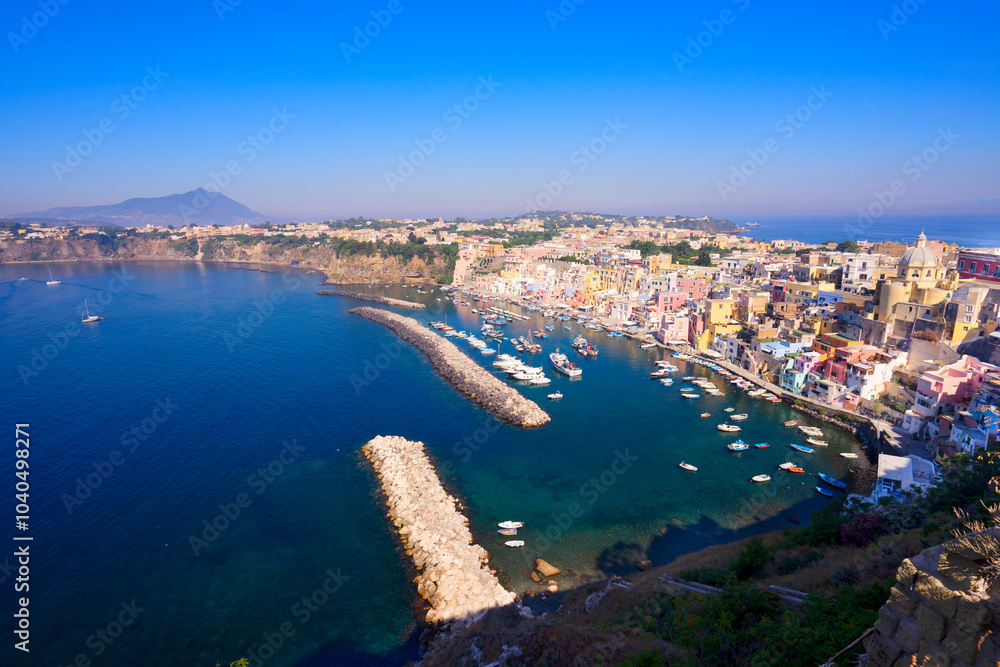 Fototapeta premium view of Procida island colorful town with small harbour from above, Italy, web banner format