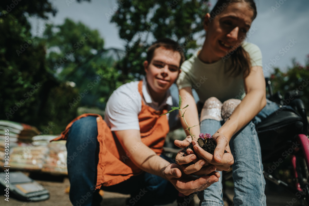 Fototapeta premium A young man and woman engage in gardening, planting a small seedling outdoors. They are collaborating and enjoying nature, symbolizing teamwork and connection with the environment.