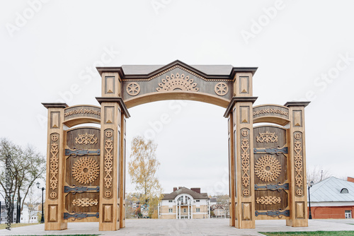 Russian North Gates, large wooden gates with decorative ornament, art-object of Vyatka wooden architecture using wood carving, area fof tourists, located in Kirov, Russia photo