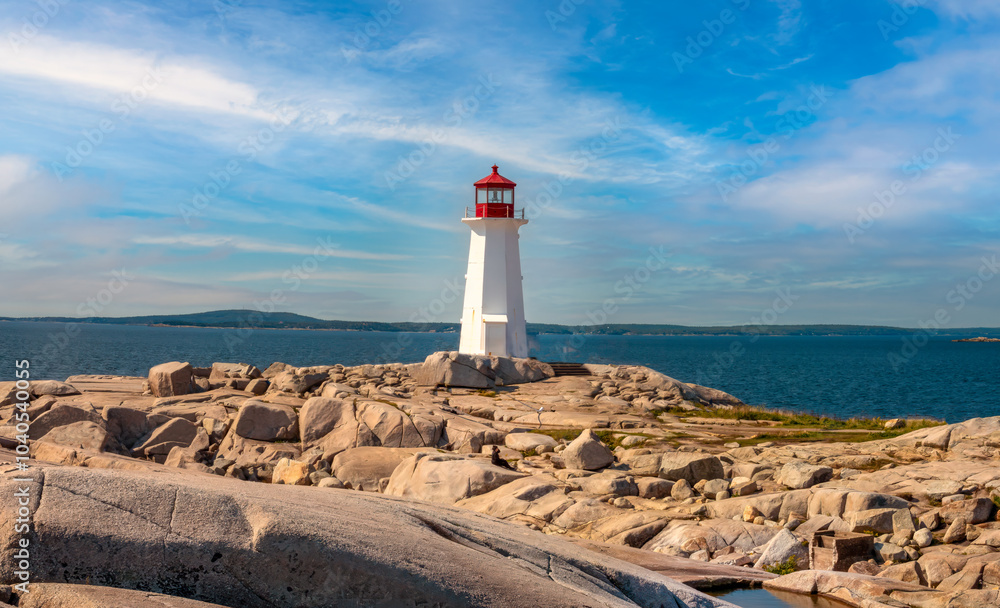 The famous lighthouse of Peggy's Cove, surrounded by stunning rock formations and boulders, Nova Scotia, Canada