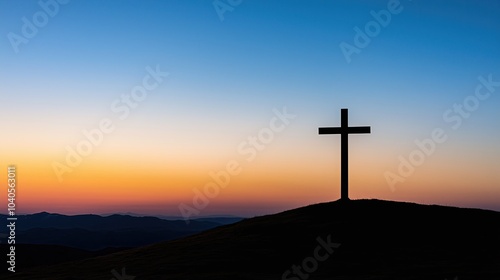 A cross standing tall on a hill at sunrise, symbolizing hope and resurrection.