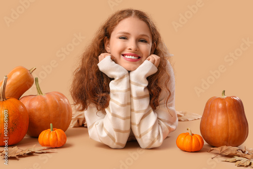 Young woman with pumpkins a...