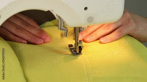 The process of sewing fabric on a sewing machine, The sewing machine needle in motion