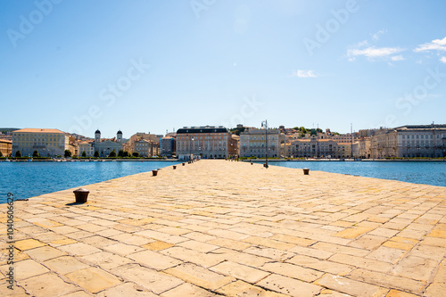 The pier Molo Audace along the shores of Trieste stretching out in the sea, in front of Piazza Unita d'Italia. photo