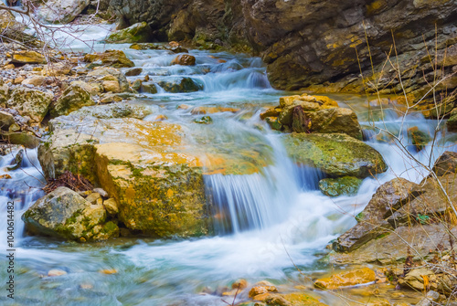 emerald river rushing through canyon with forest on coast