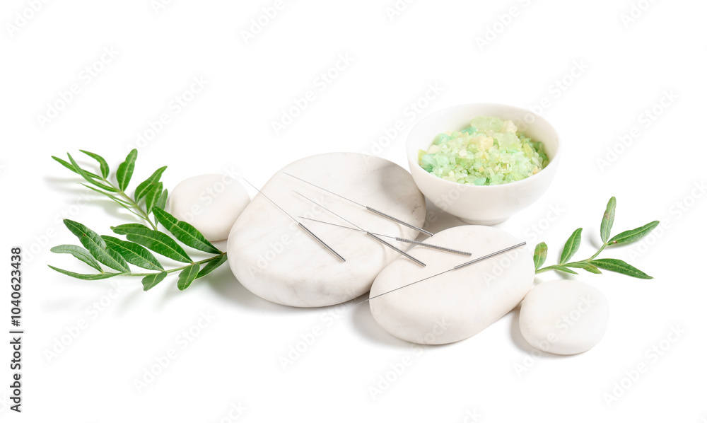 Acupuncture needles, sea salt and spa stones on white background Acupuncture needles, sea salt and spa stones on white background