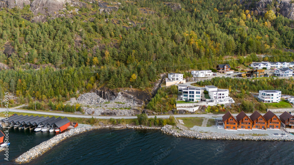 Obraz premium Aerial View of Coastal Village Along Fjord in Autumn