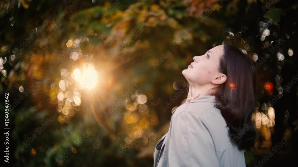 woman in autumn coat enjoying autumn landscape in forest, yellow leaves on trees woman in autumn coat enjoying autumn landscape in forest, yellow leaves on trees