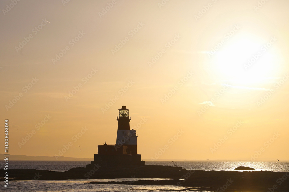 sun going down over lindesfarne lighthouse sun going down over lindesfarne lighthouse