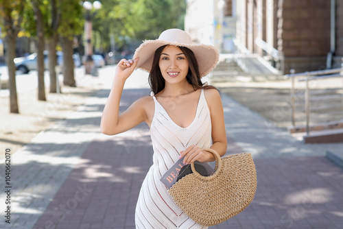 Smiling young woman in summ...