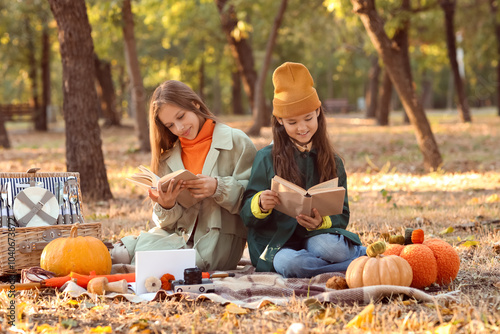 Cute girls reading books on...