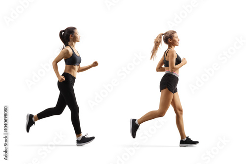 Full length profile shot of a female friends jogging