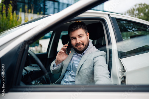 Businessman talking on the phone while sitting in car