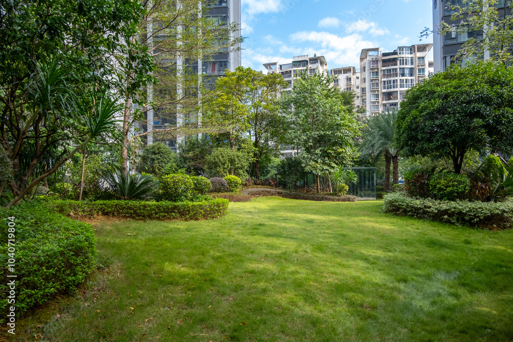 © Doublelee - Contemporary residential landscape featuring trees and grass lawn in manicured gardens, surrounded by modern high-rise apartments. A communal public outdoor space in a populated Chinese neighborhood © Doublelee - Contemporary residential landscape featuring trees and grass lawn in manicured gardens, surrounded by modern high-rise apartments. A communal public outdoor space in a populated Chinese neighborhood
