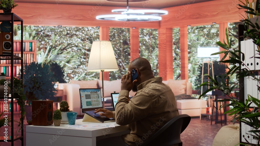 Fototapeta premium Entrepreneur reviewing statistics data on a laptop remotely from his house, makes a briefing report. Business owner studying sales numbers and the profit to increase organizational funds. Camera B.