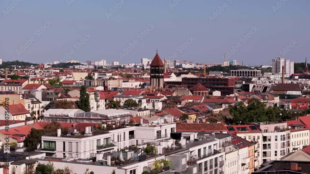 Aerial views showcase Berlin's stunning skyline, featuring iconic church steeples of Church of the Sacred Heart in Prenzlauer Berg and vibrant red roofs