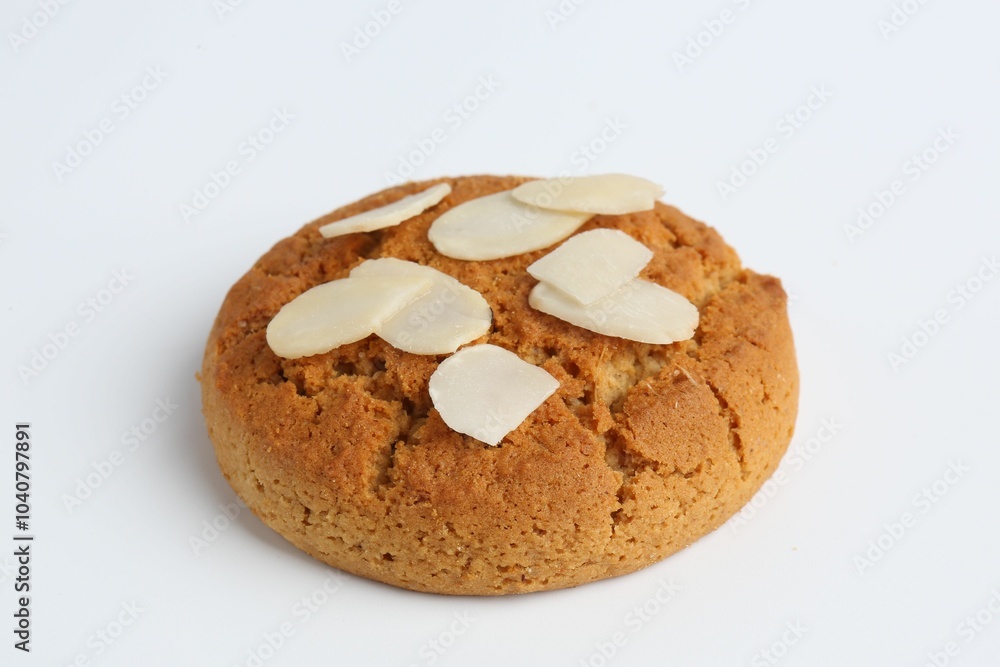 One tasty cookie with almond flakes on white background One tasty cookie with almond flakes on white background