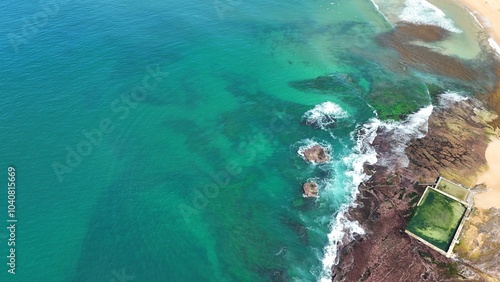 Aerial view drone shot of a beach with clear water 
