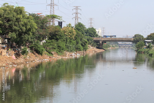 Ciliwung river alongside jalan Tanggul Banjir Kanal Barat, West Jakarta, Indonesia. photo