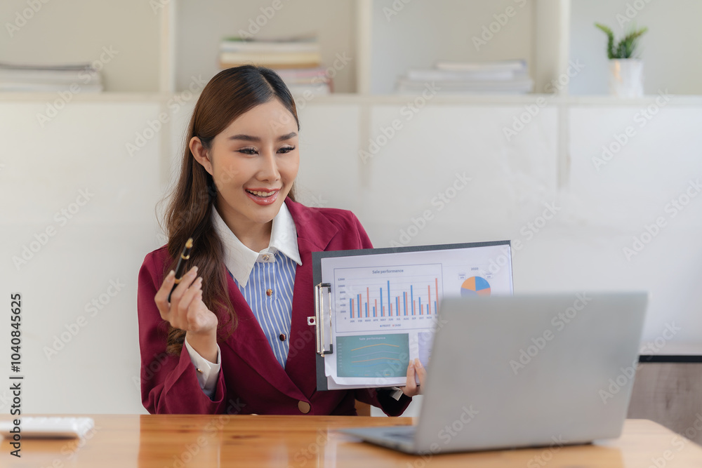 Asian businesswoman working with new project idea presentation, analyzing marketing and investment plans with financial graph documents and laptop. Asian businesswoman working with new project idea presentation, analyzing marketing and investment plans with financial graph documents and laptop.