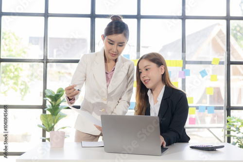 Two women talk, discuss, work on new project ideas. Analyze marketing plans and business investments to ensure success.