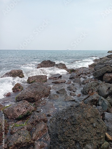 Waves crashing against the rocks on the shore