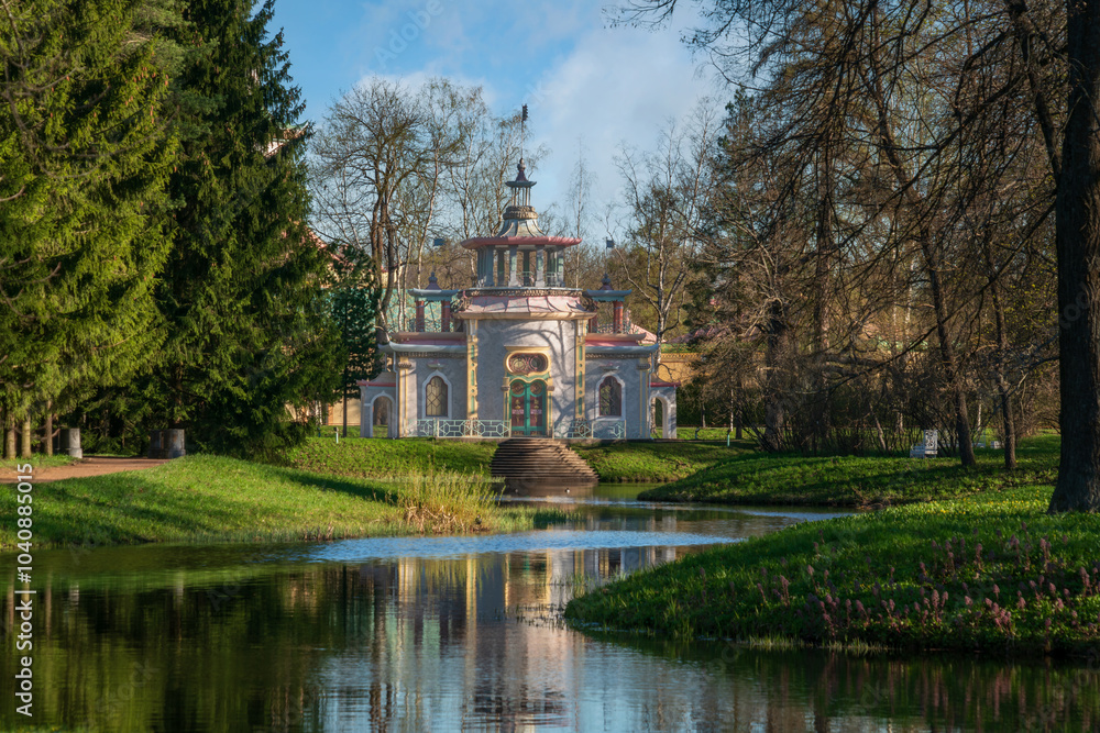 Chinese gazebo on the bank of the Upper Ponds in the Catherine Park in Tsarskoye Selo on a sunny spring day, Pushkin, St. Petersburg, Russia Chinese gazebo on the bank of the Upper Ponds in the Catherine Park in Tsarskoye Selo on a sunny spring day, Pushkin, St. Petersburg, Russia