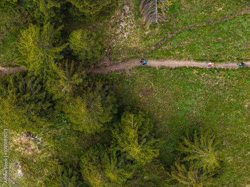 Aerial birds eye view of a group of people hiking in the forest of the mountains. Hiking concept photo. photo