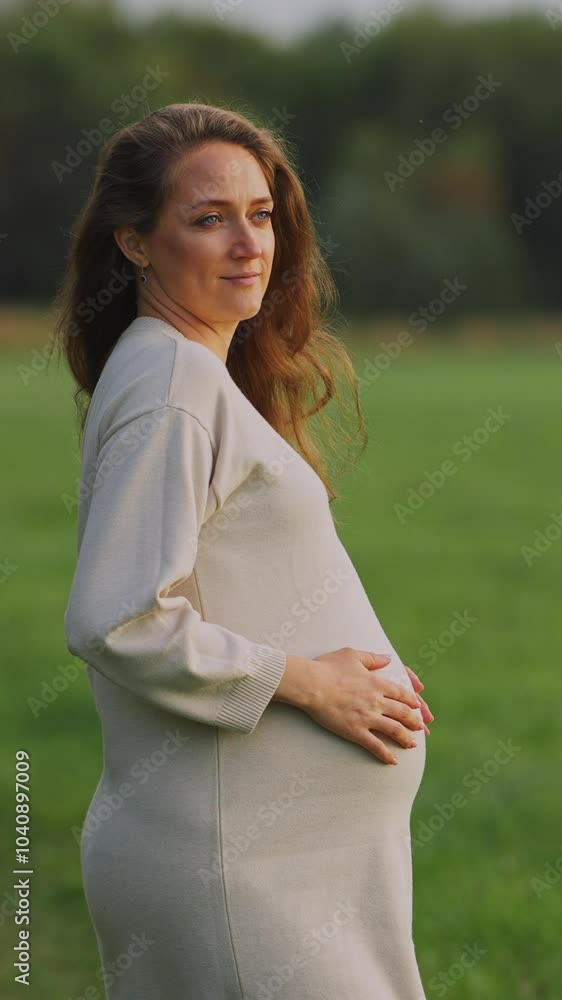 Expecting joy in nature: A serene moment with a pregnant woman in a field