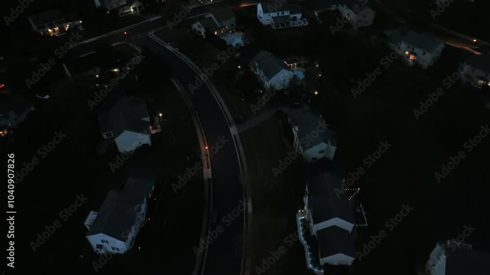 Aerial top down shot of lighting lantern on main street of dark neighborhood at night, USA. Single family houses in american suburb. Aerial top down shot of lighting lantern on main street of dark neighborhood at night, USA. Single family houses in american suburb.