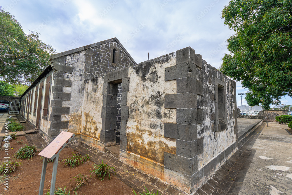 The weathered facade of a historic building at Sucre Adventure Park, Mauritius. Stone walls and arched windows offer a glimpse into the island's rich colonial past. Sucre Adventures, Mauritius. The weathered facade of a historic building at Sucre Adventure Park, Mauritius. Stone walls and arched windows offer a glimpse into the island's rich colonial past. Sucre Adventures, Mauritius.