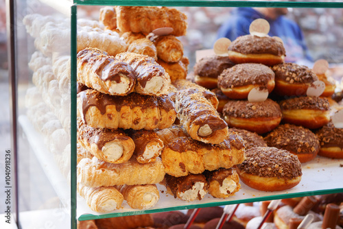 Fotografie A beautifully arranged assortment of delicious pastries and donuts on display at