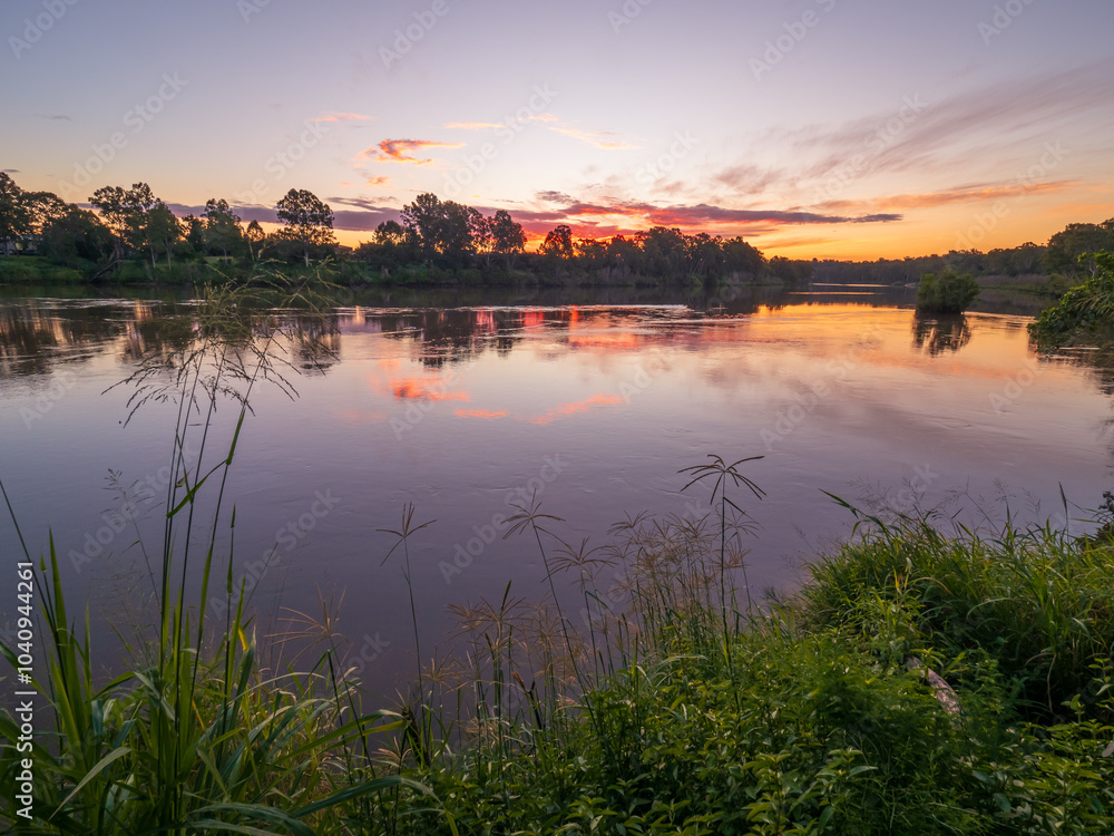 Fototapeta premium Sunset by the River with Reflections