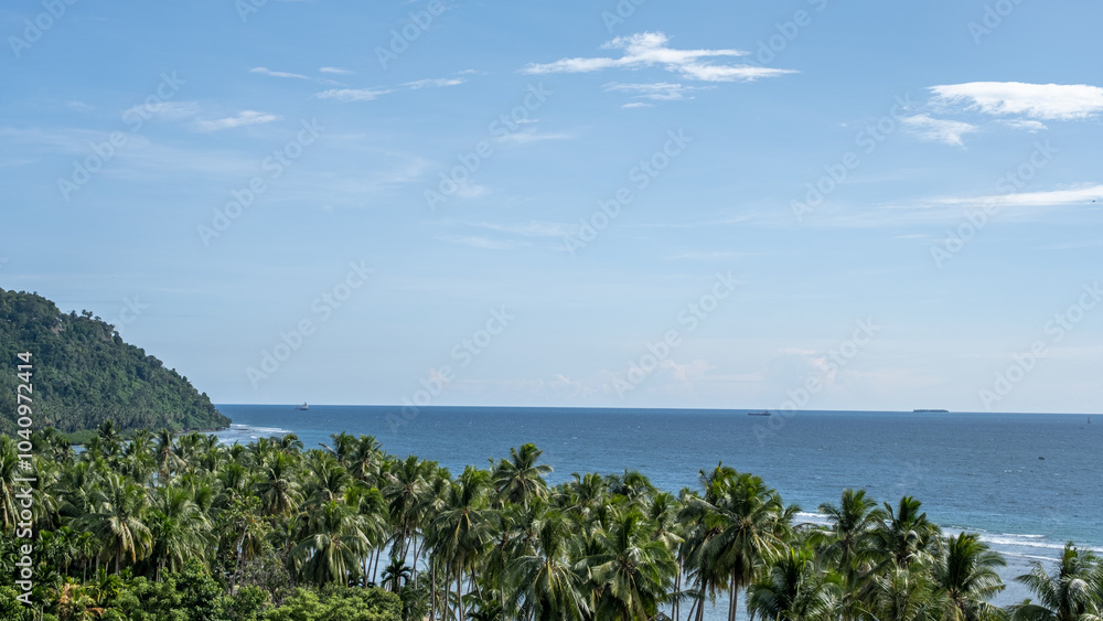 Aerial view of the open sea with coconut trees and a bright blue sky in Mentawai, Indonesia. A tropical paradise perfect for travel enthusiasts, capturing the beauty of Asia’s coastal landscapes. Aerial view of the open sea with coconut trees and a bright blue sky in Mentawai, Indonesia. A tropical paradise perfect for travel enthusiasts, capturing the beauty of Asia’s coastal landscapes.