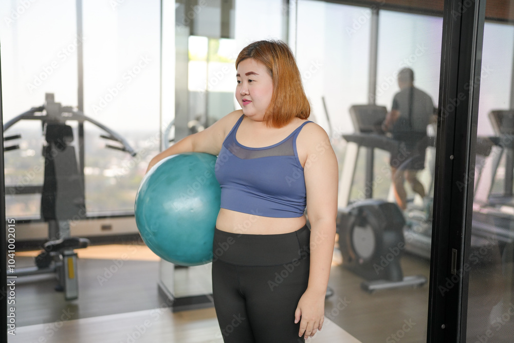 Fototapeta premium Sporty woman exercising on ball&nbsp;fitness workout and health concept. training working out and sitting on gymnastic fitball&nbsp;at gym
