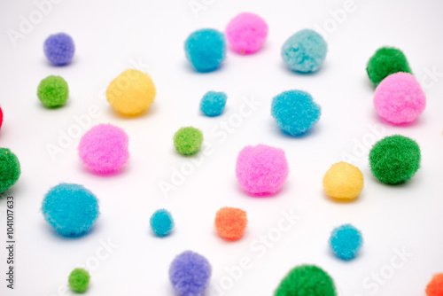 A bunch of pom poms in various colors