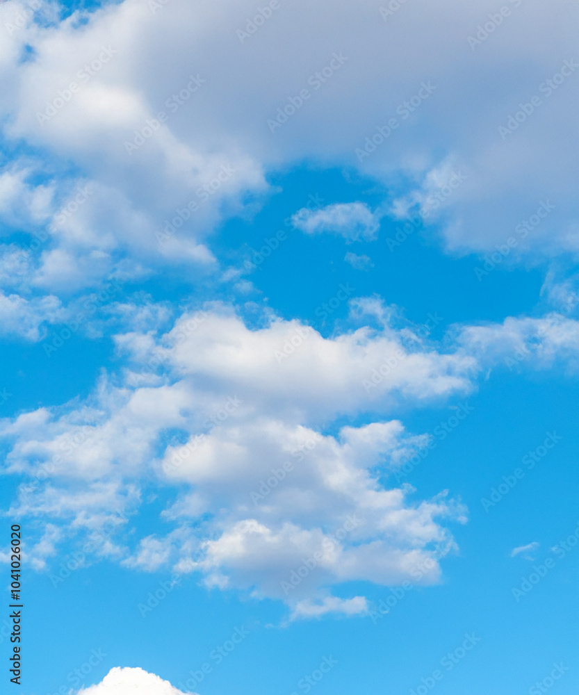 A peaceful scene of a blue sky dotted with soft, white cumulus clouds, perfect for backgrounds and design. A peaceful scene of a blue sky dotted with soft, white cumulus clouds, perfect for backgrounds and design.