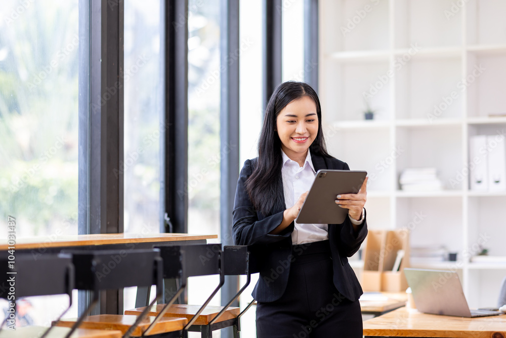 Female business person using digital tablet and laptop or remote working at office, looking at digital tablet watching webinar, learning training, studying online seminar or video calling.
Female business person using digital tablet and laptop or remote working at office, looking at digital tablet watching webinar, learning training, studying online seminar or video calling.