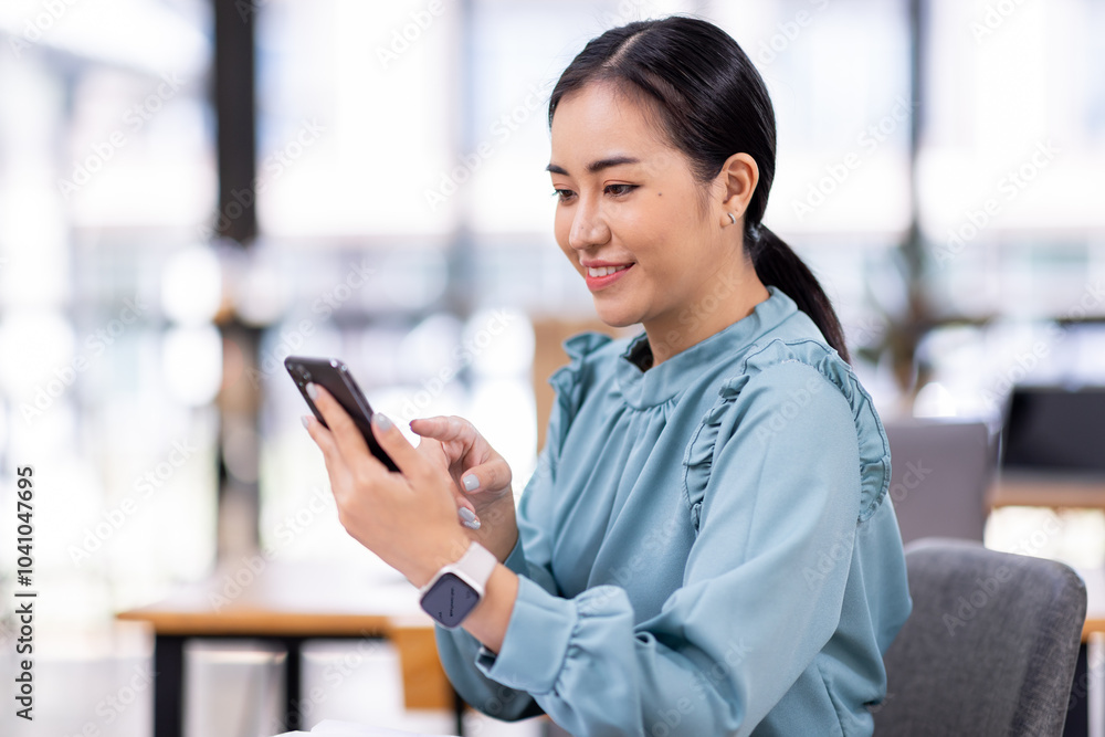 Portrait of a happy Asian businesswoman using mobile phone indoor, Asian businesswoman working in modern office.
Portrait of a happy Asian businesswoman using mobile phone indoor, Asian businesswoman working in modern office.