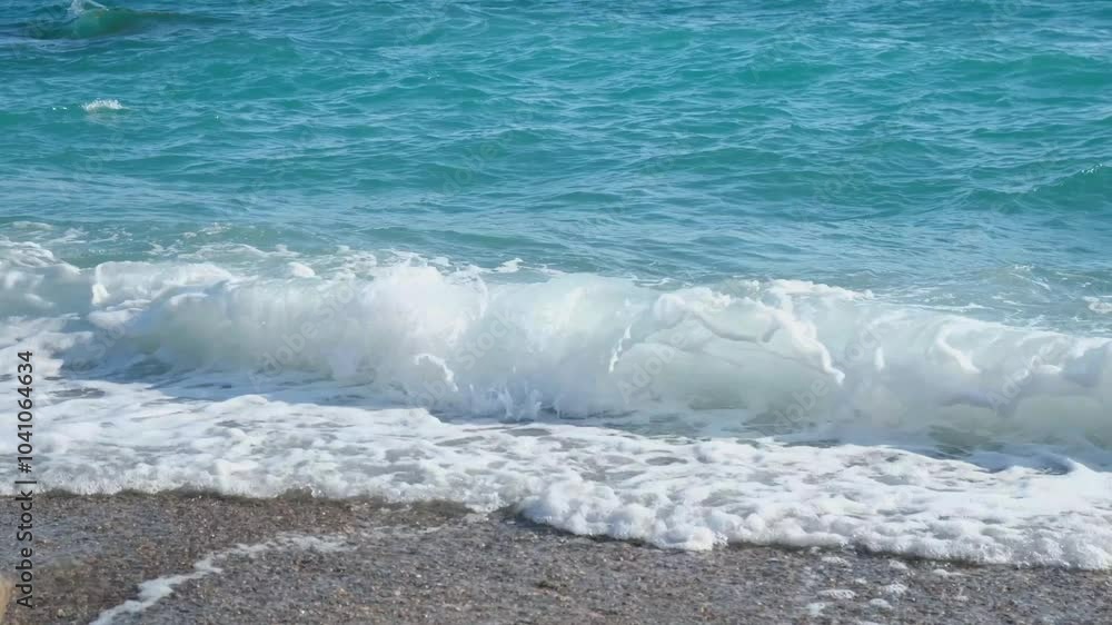 Turquoise wave beach slow motion. The purest warm rolling on a pebble beach close-up. Sparkling ocean waves. The concept of rest relaxation privacy. Perfectly clean water. Natural tropical background. Turquoise wave beach slow motion. The purest warm rolling on a pebble beach close-up. Sparkling ocean waves. The concept of rest relaxation privacy. Perfectly clean water. Natural tropical background.
