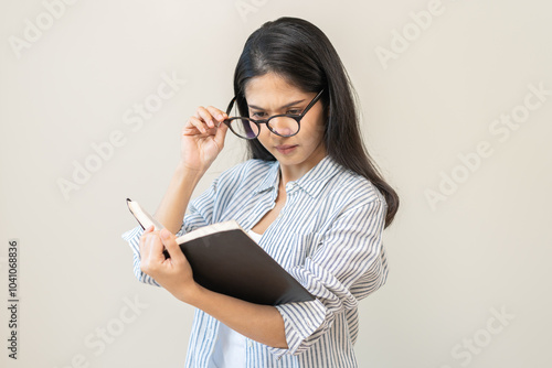 Presbyopia, hyperopia middle aged asian woman holding eyeglasses problem with vision blurred, female stare trying to read text on book at home, eye disease of old, eyesight farsightedness, health care