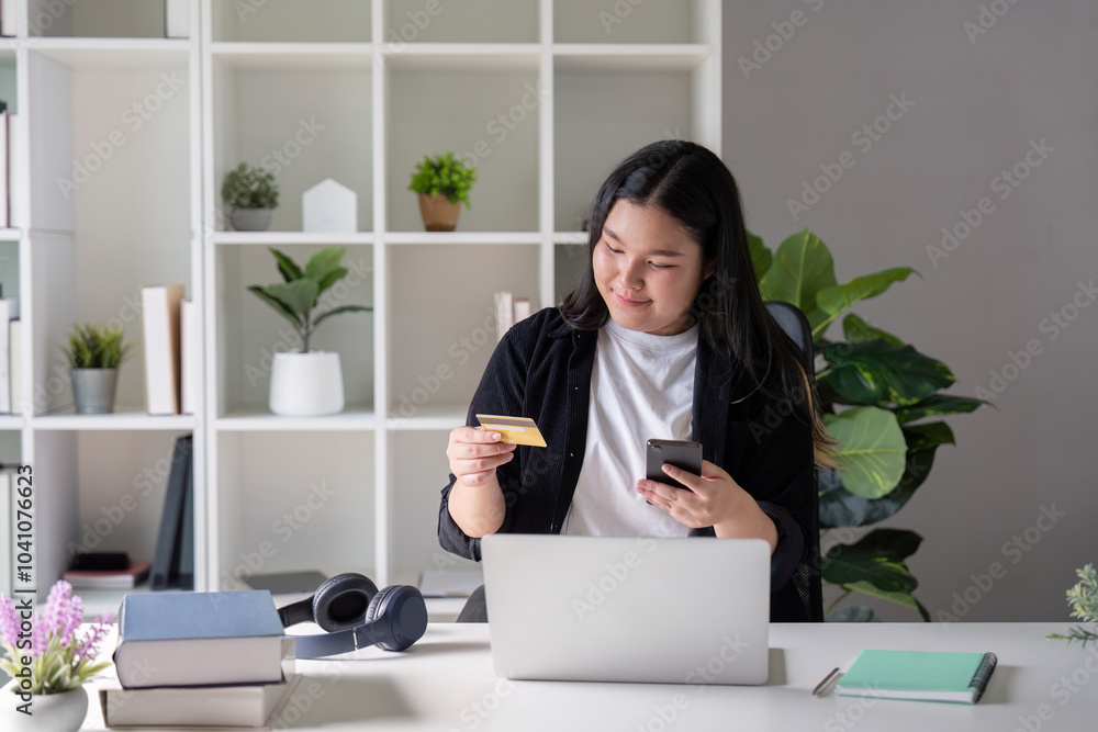Young Woman Conducting Online Transactions with Card and Smartphone Young Woman Conducting Online Transactions with Card and Smartphone