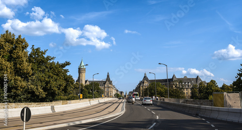 Driving Across Adolphe Bridge toward Spuerkeess Building on a Clear Summer Day - Luxembourg City