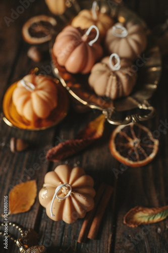 Handmade wax candle in the shape of pumpkins on a dark background