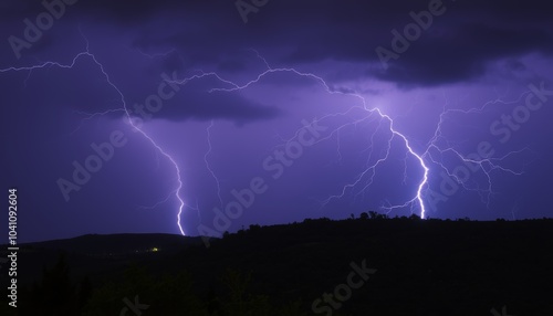 Lightning Bolts Illuminating Night Sky Over Silhouetted Hills