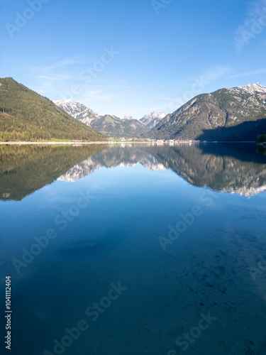 Achensee good morning sunrise moment with a flat and quite reflection scenic lake