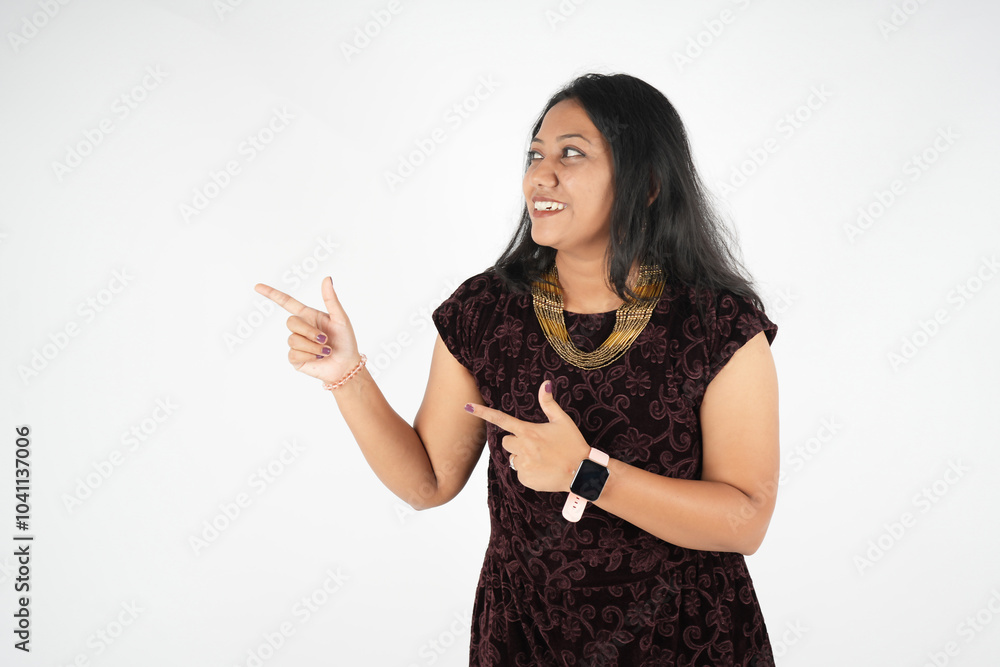 women pointing fingers right, showing promo offer or advertisement, demonstrating banner, standing against beige women pointing fingers right, showing promo offer or advertisement, demonstrating banner, standing against beige